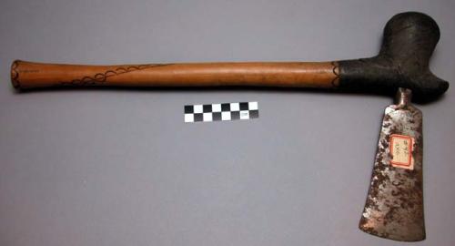 Native axe of wooden handle and metal blade