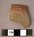 Potsherd - reddish burnish inside & exterior rim; rocker design on exterior