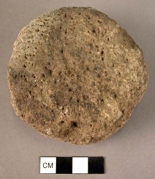 Stone, ground stone implement, brown, discoidal, net sinker?, pitted