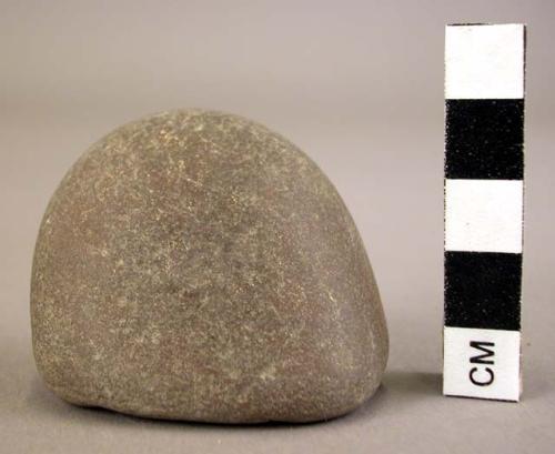 Ground stone fragment, polished, rounded at one end