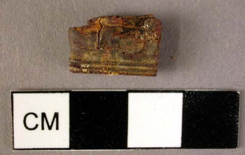 Fragmentary, small, rectangular amber pendant, decorated with ridges