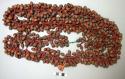 Necklace of shasha seeds - each seed on end of short pendant of red +