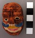 Miniature plaster mask - brown grotesque face with white mouth & eyes +