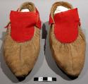 Pair of leather moccasins with red felt decoration