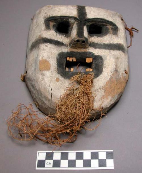 Carved wooden mask for dance - root attached for beard.  Linongo