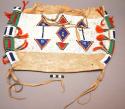 Skin saddle bag with bead decoration, orange tassels