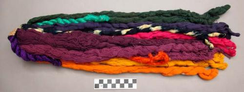 Hanks of weaving cotton - many probably commercially dyed - yellow, orange, blue