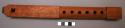Wooden flute of light porous wood. 6 note apertures, mouthpiece carved in two se