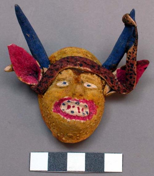 Miniature plaster mask - yellow grotesque face, white mouth & eyes, +