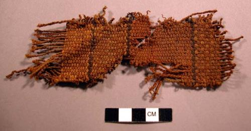 Woven fiber fragment, black & brown dye, worn