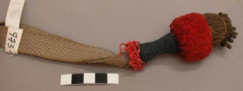 Woven tassles of wool, attached to bands, a) red, brown, and blue tassle: 3 1/2"