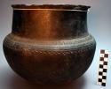 Black pottery cooking vessel with incised designs. Mkate