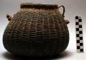 Basket container with braided grass handle