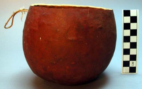 Gourd vessel with fiber string handle.  Chipanda