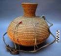 Globular basketry water jug with constricted neck.