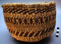Medium-sized utility basket.  Roughly twined from bear grass.