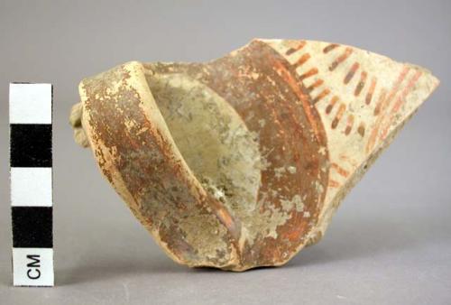 Red painted pottery handle fragment with pattern in dark rays