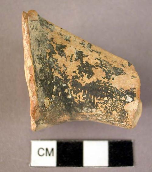 Ceramic spout sherd, angled, black over buff, worn