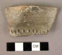 Fragment of storage (pottery) jar with single row of nail cuts at base of rim-ba
