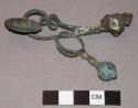 Fibula with ring and pendant attached
