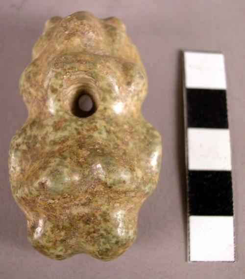 Polished serpentine pendant, depicting were-jaguar figure (?).  Perforations at