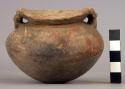 Pottery jar, handles, human figure, conventionalized