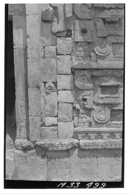 Monjas - E. facade E. wing N. side of door showing stones replaced with much mor