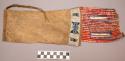 Sioux tobacco bag. Piece of buckskin folded over & stitched w/ thread. Cloth tri