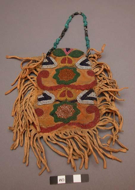 Man's toilet case of skin--fringed, beaded loop handle; beadwork design on side