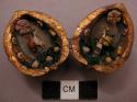 Walnut shells, containing small figures