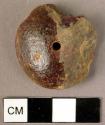 Fragmented, disk-shaped amber pendant drilled in two places