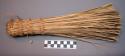 Whisk broom regularly used for sweeping around huts. Lisache