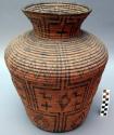 Medium-sized jar-shaped basket, coiled. Made of bear grass and devil's claw.