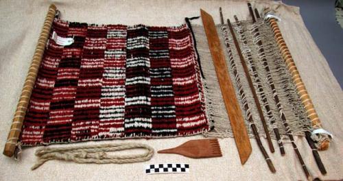 Small rug on loom, black, white, and red checked design