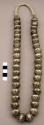 Necklace, 1 strand handmade silver beads w/ stamped design, navajo wrap