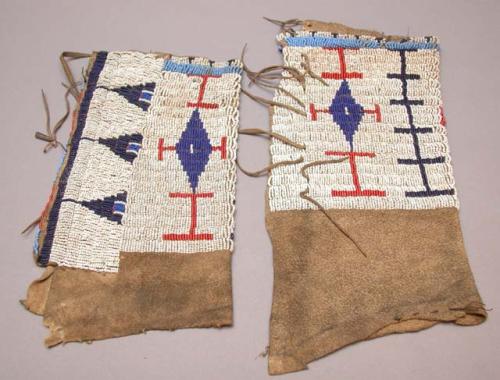 One pair of leggings--skin with beadwork of red, light and dark blue on white