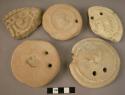 5 pottery weights or bread moulds