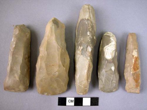 Chipped stone bifaces, adzes, chisels and gouges, grey stone, some w. cortex