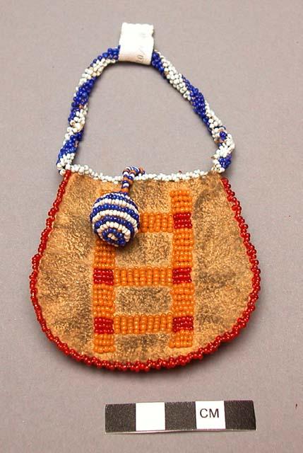 Small beaded leather pouch. Front of pouch completely decorated with beadwork.