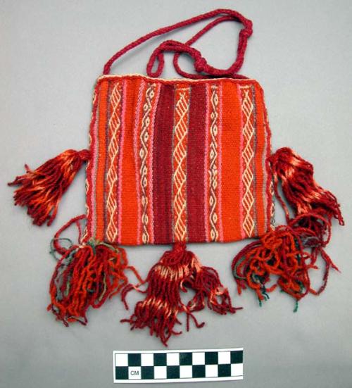 Tapestry bag, wool, trimmed with four large tassels. narrow verical bands of whi