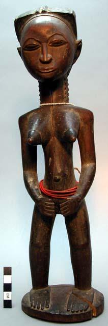 Standing female ancestor figure with finely incised coiffure, hands held in fron