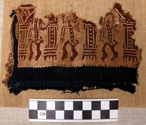 Textile fragment.  Wool fibres.  Human figure design.  6" long, 4" wide.