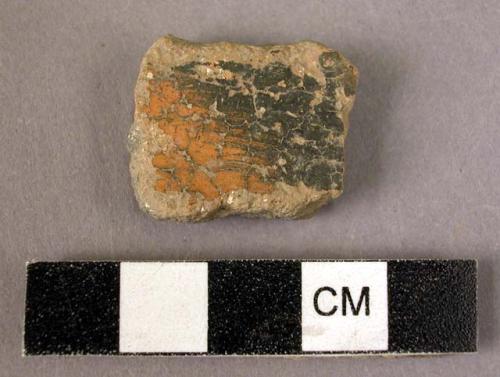 Potsherd - shiny black and orange outside; dull black inside; micaceous