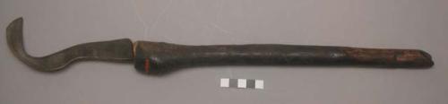 Bill hook, club-shaped handle with iron blade, worn thin from use (nkusu)