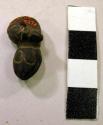 Lignite ornament - shape of small snake with tail curled forming +
