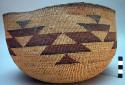 Twined basket. Deep bowl shape, posibly a cooking basket. Geometric designs