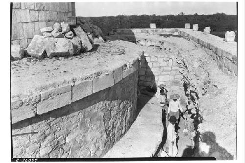 Masons walling up pit exposing 1929 circular structure. Caracol.