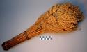 Broom, bundle of dried grass stalks bound w/ veg. fiber, shedding