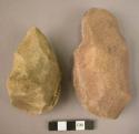 2 heavily rolled crude quartzite hand axes