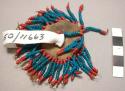 Blue and red beaded fragment, with 1.5 in. leather patch center